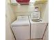 Laundry closet with a white washer and dryer set, plus shelving above for storage at 9820 Queensway Blvd. # 501, Myrtle Beach, SC 29572