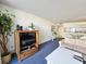 Bright living area with a TV, sofa, and view of the kitchen at 9820 Queensway Blvd. # 501, Myrtle Beach, SC 29572