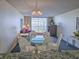 Cozy living room with a glass dining table, plush seating, and sliding doors leading to the balcony at 9820 Queensway Blvd. # 501, Myrtle Beach, SC 29572
