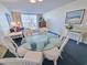 Bright and airy living room with a glass dining table, comfortable seating, and balcony access showcasing natural light at 9820 Queensway Blvd. # 501, Myrtle Beach, SC 29572