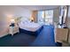 Serene bedroom featuring a king bed, dresser, and private balcony access with city views at 9820 Queensway Blvd. # 501, Myrtle Beach, SC 29572