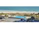 Elevated pool deck with ocean view, lounge chairs, and parking lot at 9820 Queensway Blvd. # 501, Myrtle Beach, SC 29572