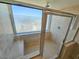 Walk-in shower features clear glass enclosure, tile surround, and a convenient built-in bench at 9820 Queensway Blvd. # 501, Myrtle Beach, SC 29572