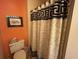 Cozy bathroom features a patterned shower curtain and orange walls at 220 Landing Rd. # I, North Myrtle Beach, SC 29582