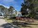 Attractive entrance to a community featuring lush landscaping and an inviting welcome sign at 220 Landing Rd. # I, North Myrtle Beach, SC 29582