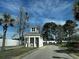 Community entrance featuring a paved drive, guard house, mature trees and landscaping at 220 Landing Rd. # I, North Myrtle Beach, SC 29582