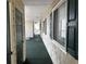 Outdoor condo hallway featuring shake siding, dark trim, and rocking chairs for comfortable seating at 220 Landing Rd. # I, North Myrtle Beach, SC 29582