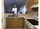 Open kitchen featuring wood cabinets and stainless steel sink with bar overlooking the living room at 220 Landing Rd. # I, North Myrtle Beach, SC 29582