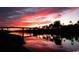 Dramatic sunset over a waterway reflecting vibrant colors, with silhouetted trees and a bridge at 220 Landing Rd. # I, North Myrtle Beach, SC 29582