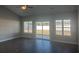 Bright living room with hardwood floors and sliding glass doors leading to backyard at 2347 King Farm Rd., Aynor, SC 29511