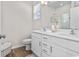 Modern bathroom with double vanity, sleek fixtures, white cabinetry, and hardwood floors at 3035 Deerberry Place, Longs, SC 29568