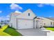 Charming home features neutral siding, a two-car garage, manicured landscaping, and a covered front porch at 3035 Deerberry Place, Longs, SC 29568