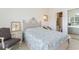 Well-lit bedroom features a decorative headboard, side table, and golf course views at 4733 Wild Iris Dr. # 302, Myrtle Beach, SC 29577