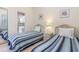 Bedroom featuring twin beds, neutral walls, and access to an ensuite bathroom at 4733 Wild Iris Dr. # 302, Myrtle Beach, SC 29577
