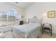 Comfortable bedroom with a large window offering scenic golf course views at 4733 Wild Iris Dr. # 302, Myrtle Beach, SC 29577