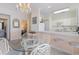 Cozy dining area adjacent to the kitchen with a glass table and wicker chairs at 4733 Wild Iris Dr. # 302, Myrtle Beach, SC 29577