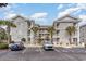 Charming condo complex featuring stone facade, multiple floors, and ample parking for residents and guests at 4733 Wild Iris Dr. # 302, Myrtle Beach, SC 29577