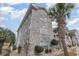 Stunning low-angle view of the building's exterior, showcasing the beautiful architectural design and well-kept grounds at 4733 Wild Iris Dr. # 302, Myrtle Beach, SC 29577