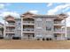 A scenic exterior view of condos featuring multiple floors with balconies, combining comfort and outdoor appeal at 4733 Wild Iris Dr. # 302, Myrtle Beach, SC 29577