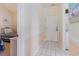 Bright hallway with tile flooring leading to bedroom and laundry, blending functionality with beachside charm at 4733 Wild Iris Dr. # 302, Myrtle Beach, SC 29577