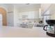 Bright kitchen features white cabinetry, modern appliances, and a breakfast bar at 4733 Wild Iris Dr. # 302, Myrtle Beach, SC 29577