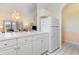 Bright kitchen with white cabinetry, providing ample storage and a seamless transition to the living room at 4733 Wild Iris Dr. # 302, Myrtle Beach, SC 29577