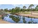Scenic view of the tranquil pond reflecting the surrounding trees and golf course at 4733 Wild Iris Dr. # 302, Myrtle Beach, SC 29577