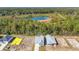 Aerial view of new construction homes surrounded by woods and a scenic lake at 397 Sun Colony Blvd., Longs, SC 29568