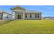 Spacious backyard featuring a well-maintained lawn and patio with sliding glass door at 397 Sun Colony Blvd., Longs, SC 29568
