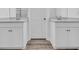 Bright bathroom featuring a double sink vanity, modern fixtures, and wood-look flooring at 397 Sun Colony Blvd., Longs, SC 29568