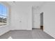 Clean and simple bedroom featuring plush carpet, a large window, and a spacious closet at 397 Sun Colony Blvd., Longs, SC 29568