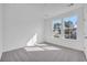 Bright bedroom with plush carpet, dual windows, and a neutral color scheme at 397 Sun Colony Blvd., Longs, SC 29568