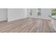 Open living room with wood-look floors and large windows at 397 Sun Colony Blvd., Longs, SC 29568