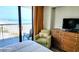Bedroom with a chair and floral pillow with a view of the beach at 9550 Shore Dr. # 925, Myrtle Beach, SC 29572