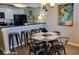Dining area with industrial style table and chairs. The kitchen includes white cabinets and black appliances at 9550 Shore Dr. # 925, Myrtle Beach, SC 29572