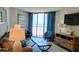 Inviting living room with a sliding glass door opening to ocean views, complemented by modern furnishings and decor at 9550 Shore Dr. # 925, Myrtle Beach, SC 29572