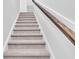 Carpeted staircase with stained wood railing and white trim at 439 Waterend Dr. # 8, Little River, SC 29566