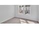 An empty bedroom offering backyard views through double windows at 233 Sandridgebury Dr. # 57, Little River, SC 29566
