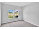 A naturally lit bedroom features two windows and carpeted floors at 233 Sandridgebury Dr. # 57, Little River, SC 29566