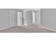 Upstairs hallway featuring carpeted floors and white doors at 233 Sandridgebury Dr. # 57, Little River, SC 29566