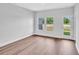 A well lit living room features hardwood flooring and access to the outdoors at 233 Sandridgebury Dr. # 57, Little River, SC 29566