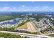 Wide aerial shot captures a community alongside a highway and serene lakeside at 293 Sandridgebury Dr. # 66, Little River, SC 29566