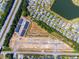 Detailed aerial view highlighting neighborhood's layout next to highway and pond at 293 Sandridgebury Dr. # 66, Little River, SC 29566