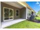 Covered patio in backyard with grass and modern AC unit at 293 Sandridgebury Dr. # 66, Little River, SC 29566