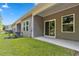 View of backyard patio with sliding glass door in residential neighborhood at 293 Sandridgebury Dr. # 66, Little River, SC 29566