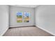 Bright bedroom featuring neutral walls, carpet floors, and large windows at 293 Sandridgebury Dr. # 66, Little River, SC 29566