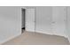 Bright bedroom featuring neutral walls, carpet floors, and two doors at 293 Sandridgebury Dr. # 66, Little River, SC 29566