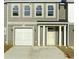 Charming townhome featuring a one-car garage and a covered front porch at 293 Sandridgebury Dr. # 66, Little River, SC 29566