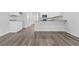 Open kitchen features modern appliances, gray countertops, and hardwood floors at 293 Sandridgebury Dr. # 66, Little River, SC 29566