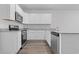 Updated kitchen with stainless steel appliances, gray counters, and hardwood floors at 293 Sandridgebury Dr. # 66, Little River, SC 29566